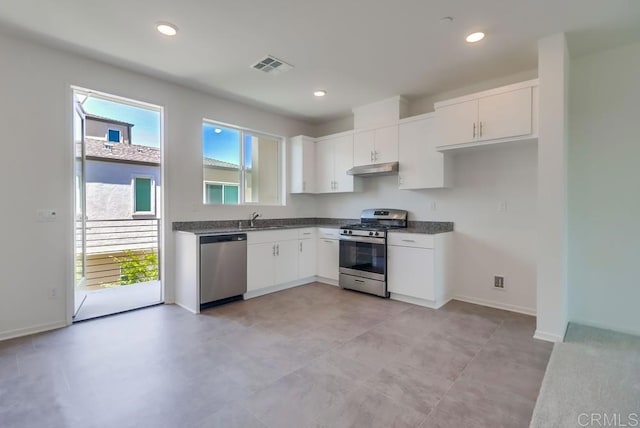 5305 Seacliff Pl Unit 5, San Diego, CA 92154 - kitchen with stainless steel appliances, dark countertops, healthy amount of natural light, white cabinetry, and recessed lighting