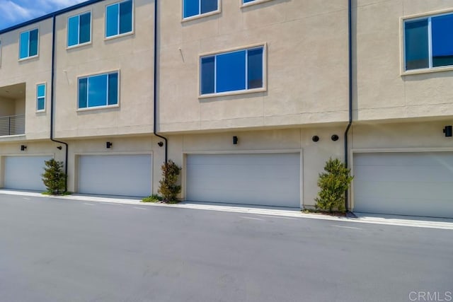 5305 Seacliff Pl Unit 5, San Diego, CA 92154 - view of front facade featuring stucco siding and a garage