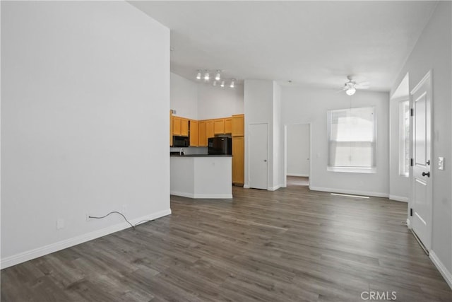 19431 Rue De Valore Unit 5C, Lake Forest, CA 92610 - unfurnished living room featuring ceiling fan, dark wood finished floors, rail lighting, and high vaulted ceiling