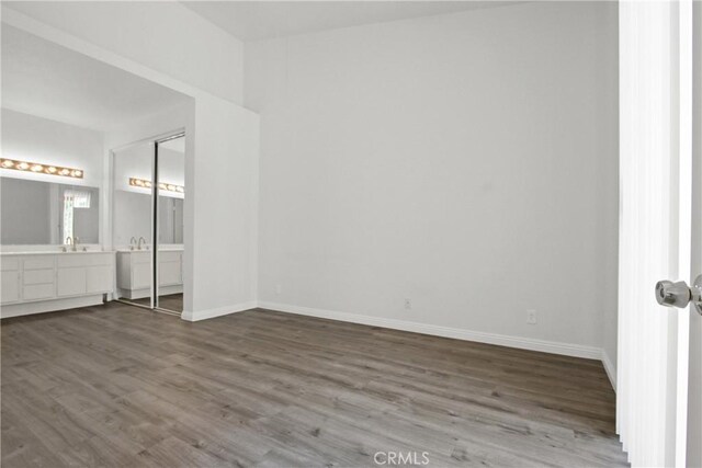 19431 Rue De Valore Unit 5C, Lake Forest, CA 92610 - unfurnished bedroom featuring dark wood-style flooring and ensuite bathroom