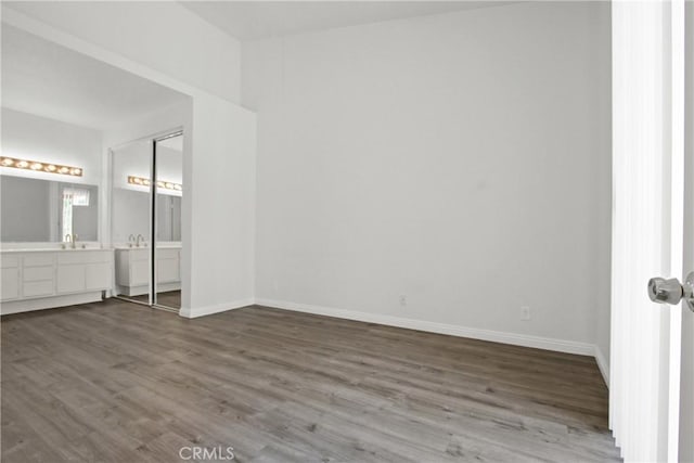 19431 Rue De Valore Unit 5C, Lake Forest, CA 92610 - unfurnished bedroom featuring dark wood-style flooring and connected bathroom