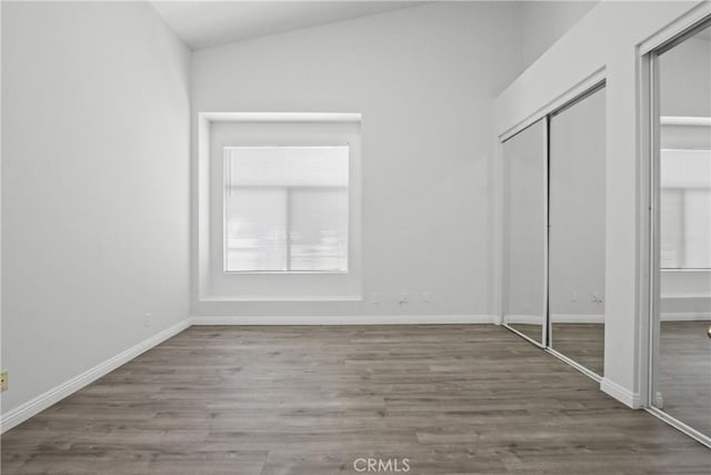 19431 Rue De Valore Unit 5C, Lake Forest, CA 92610 - unfurnished bedroom featuring wood finished floors and vaulted ceiling