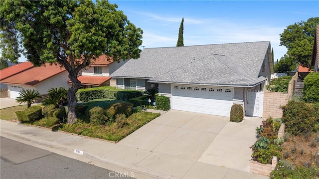 1736 Park Lawn Rd, Hacienda Heights, CA 91745 - view of front facade with a garage, driveway, and roof with shingles