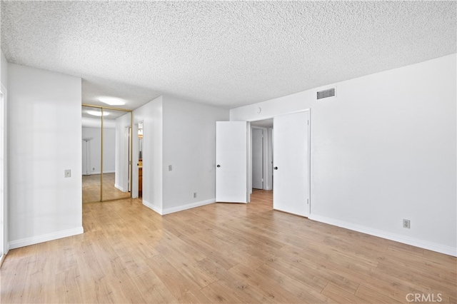 1736 Park Lawn Rd, Hacienda Heights, CA 91745 - empty room with light wood finished floors and a textured ceiling