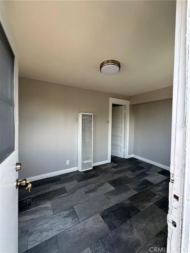 508 S Orange Ave, Santa Ana, CA 92701 - spare room featuring a heating unit and dark stone finish floors