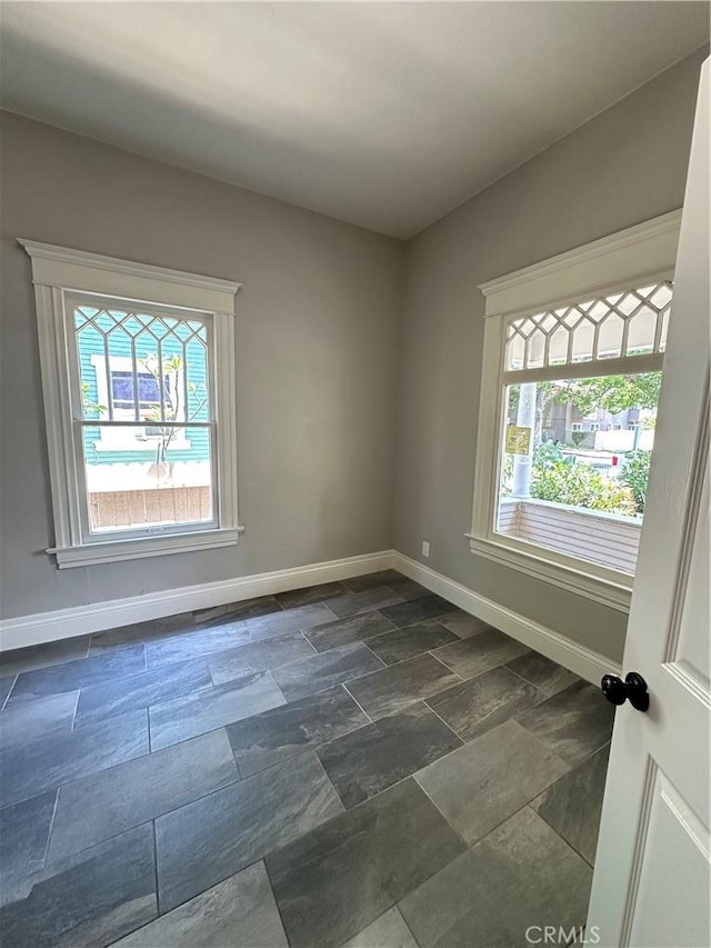 508 S Orange Ave, Santa Ana, CA 92701 - spare room featuring baseboards and dark stone finish floors