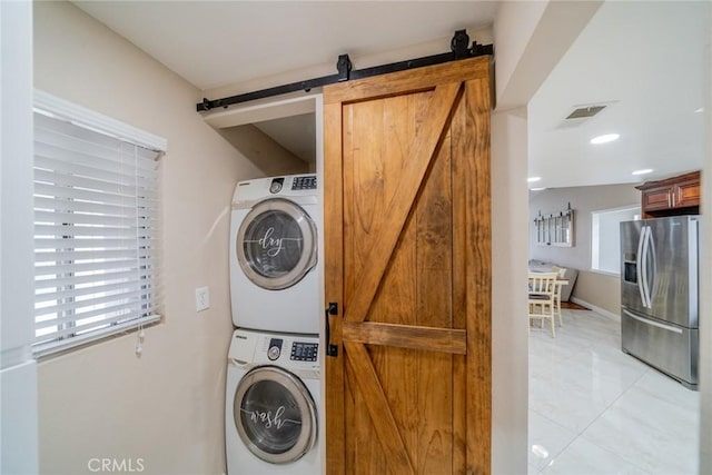 18210 Deauville Dr, Victorville, CA 92395 - washroom featuring a barn door and estacked washer and dryer
