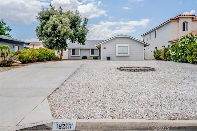 18210 Deauville Dr, Victorville, CA 92395 - single story home featuring concrete driveway and an outdoor fire pit