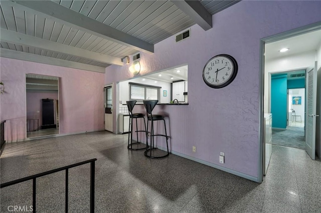 2120 N Rose St, Burbank, CA 91505 - living area featuring speckled floor and a wooden ceiling with exposed beams