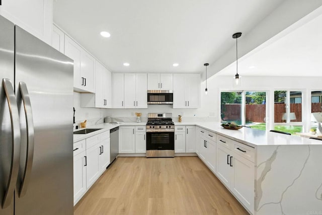 305 Spruce St, Chula Vista, CA 91911 - kitchen with stainless steel appliances, a peninsula, light wood finished floors, white cabinets, and recessed lighting