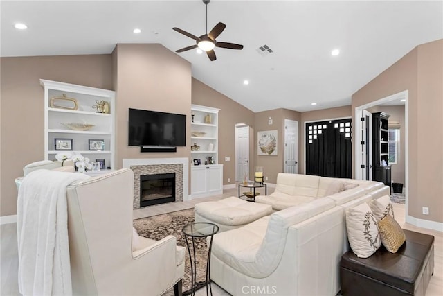 16261 Pineview Rd, Canyon Country, CA 91387 - living room with lofted ceiling, a ceiling fan, a fireplace with flush hearth, built in features, and arched walkways