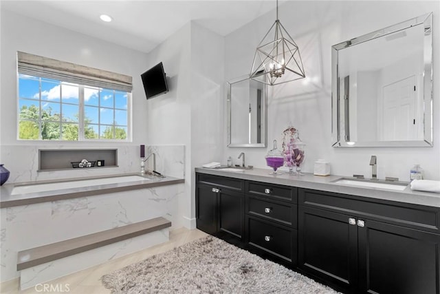 16261 Pineview Rd, Canyon Country, CA 91387 - bathroom with double vanity, a chandelier, a bath, and recessed lighting