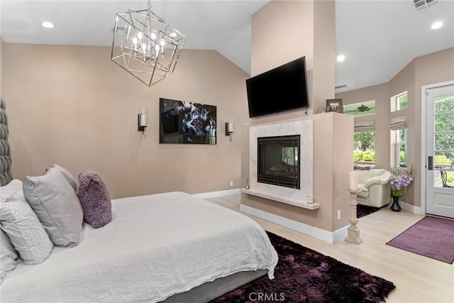 16261 Pineview Rd, Canyon Country, CA 91387 - bedroom with access to exterior, a premium fireplace, wood finished floors, a chandelier, and vaulted ceiling