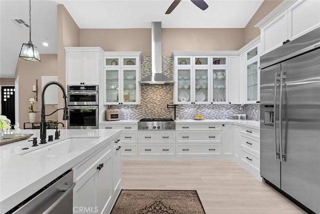 16261 Pineview Rd, Canyon Country, CA 91387 - kitchen with appliances with stainless steel finishes, wall chimney range hood, ceiling fan, backsplash, and recessed lighting