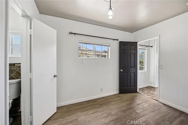 7803 Clive Ave, Whittier, CA 90606 - unfurnished bedroom featuring wood finished floors and baseboards
