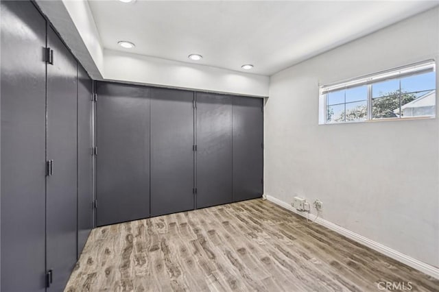 7803 Clive Ave, Whittier, CA 90606 - unfurnished bedroom with light wood-type flooring, recessed lighting, and a closet