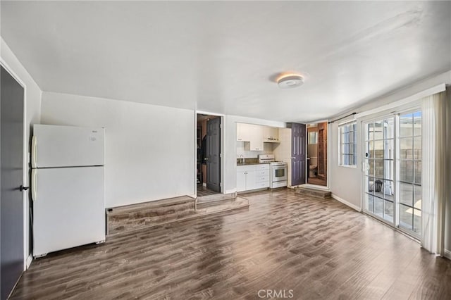 7803 Clive Ave, Whittier, CA 90606 - unfurnished living room with dark wood finished floors and baseboards