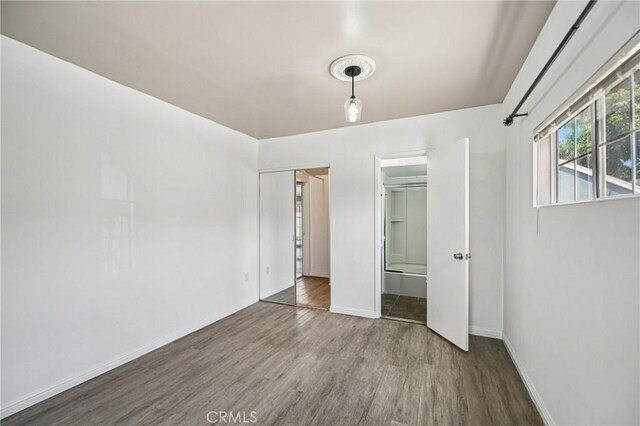 7803 Clive Ave, Whittier, CA 90606 - unfurnished bedroom featuring wood finished floors and baseboards