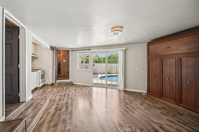 7803 Clive Ave, Whittier, CA 90606 - unfurnished living room with wood finished floors and baseboards