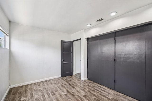 7803 Clive Ave, Whittier, CA 90606 - unfurnished bedroom with wood finished floors and a closet