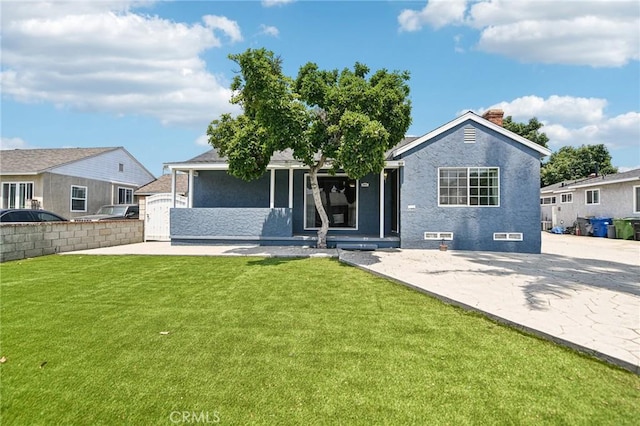 7803 Clive Ave, Whittier, CA 90606 - rear view of property with a lawn, a chimney, stucco siding, and a patio area