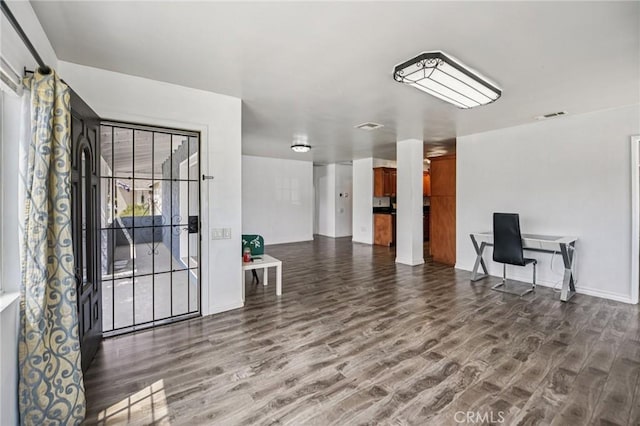 7803 Clive Ave, Whittier, CA 90606 - unfurnished living room with wood finished floors and baseboards
