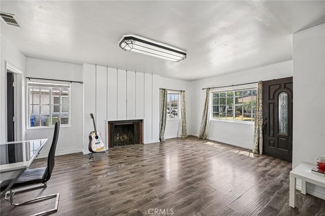 7803 Clive Ave, Whittier, CA 90606 - unfurnished living room featuring wood finished floors and a brick fireplace