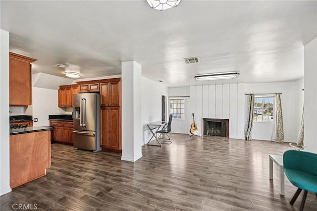 7803 Clive Ave, Whittier, CA 90606 - kitchen featuring stainless steel fridge, dark countertops, plenty of natural light, and open floor plan
