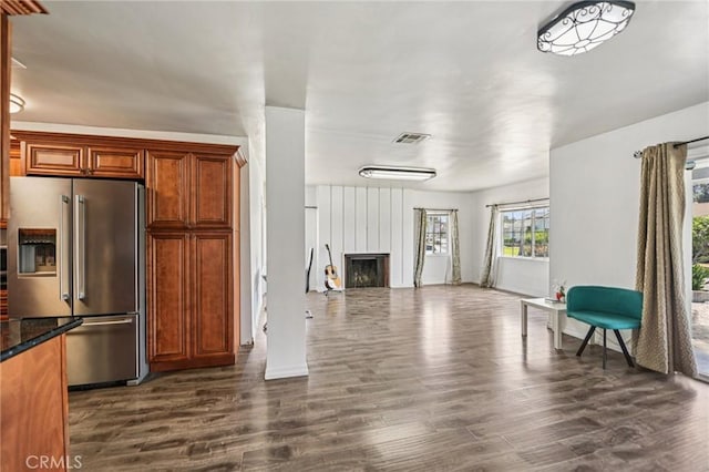 7803 Clive Ave, Whittier, CA 90606 - kitchen featuring stainless steel fridge with ice dispenser, dark wood-style flooring, a large fireplace, open floor plan, and dark stone countertops