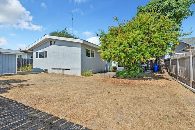 4760 73rd St, La Mesa, CA 91942 - rear view of house with a fenced backyard and stucco siding