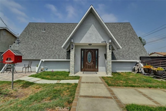4519 Bresee Ave, Baldwin Park, CA 91706 - view of front facade featuring a shingled roof, stucco siding, and a front lawn