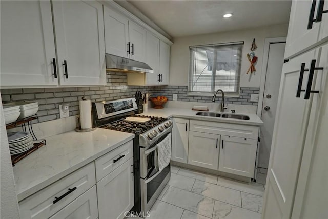 4519 Bresee Ave, Baldwin Park, CA 91706 - kitchen featuring double oven range, under cabinet range hood, light marble finish floors, white cabinetry, and decorative backsplash