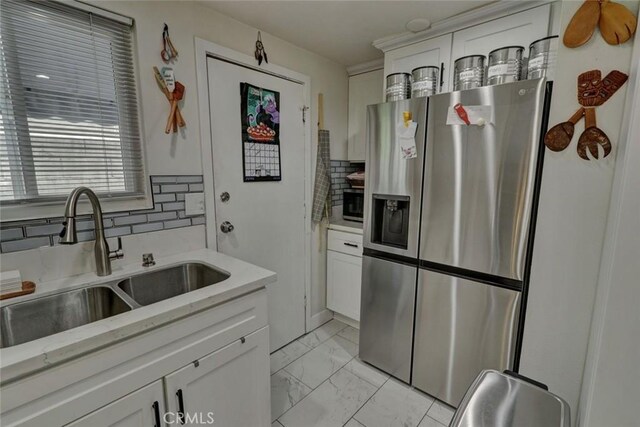 4519 Bresee Ave, Baldwin Park, CA 91706 - kitchen with stainless steel appliances, light marble finish flooring, tasteful backsplash, white cabinets, and light stone countertops