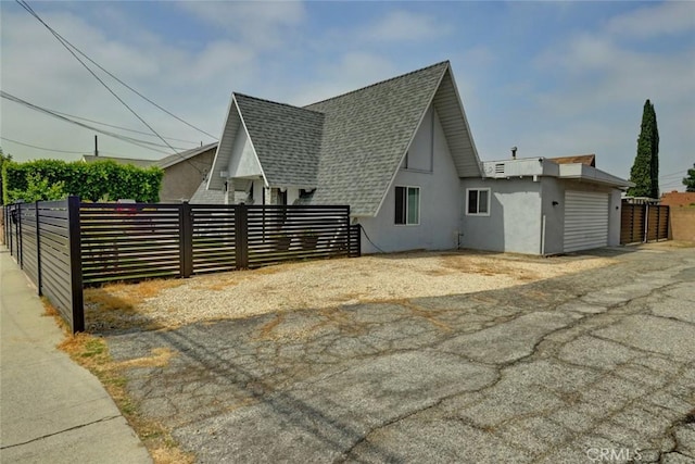 4519 Bresee Ave, Baldwin Park, CA 91706 - view of side of property with a shingled roof and stucco siding
