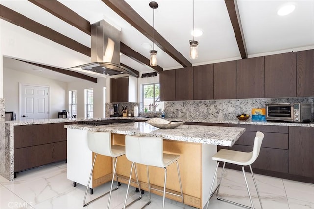19516 Blythe St, Reseda, CA 91335 - kitchen with island exhaust hood, light marble finish floors, dark brown cabinetry, decorative backsplash, and a kitchen breakfast bar