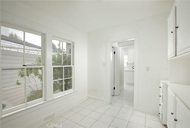 738 S Norton Ave, Los Angeles, CA 90005 - corridor featuring healthy amount of natural light and light tile patterned floors