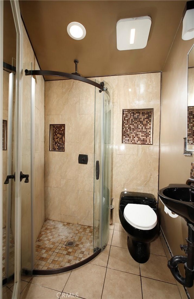 738 S Norton Ave, Los Angeles, CA 90005 - full bathroom featuring a shower stall, tile walls, and tile patterned flooring