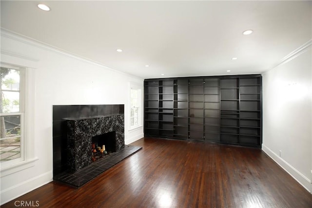 738 S Norton Ave, Los Angeles, CA 90005 - unfurnished living room with ornamental molding, wood finished floors, a high end fireplace, recessed lighting, and built in shelves