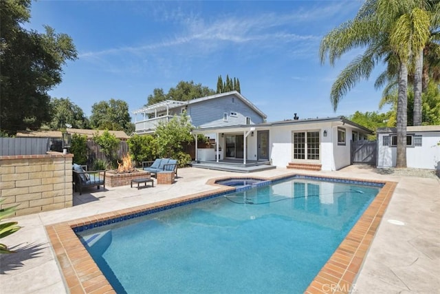 311 Prospect St, Oak View, CA 93022 - rear view of house with a patio area, a fire pit, stucco siding, an outbuilding, and a pool with connected hot tub