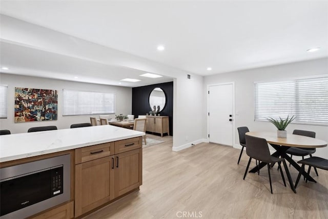 311 Prospect St, Oak View, CA 93022 - kitchen featuring stainless steel microwave, light wood-type flooring, light stone countertops, and recessed lighting