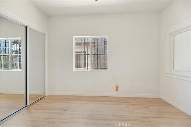 2018 W Martin Luther King Jr Blvd, Los Angeles, CA 90062 - unfurnished bedroom with light wood finished floors and a closet