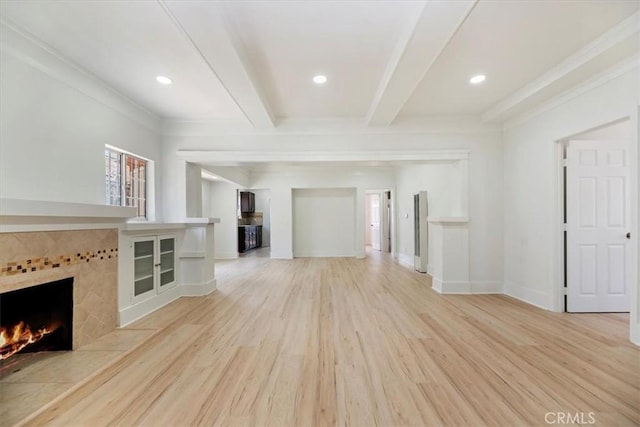 2018 W Martin Luther King Jr Blvd, Los Angeles, CA 90062 - unfurnished living room with light wood-style floors, beam ceiling, a tile fireplace, recessed lighting, and ornamental molding