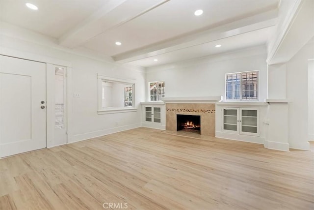 2018 W Martin Luther King Jr Blvd, Los Angeles, CA 90062 - unfurnished living room with wood finished floors, beam ceiling, a premium fireplace, and recessed lighting