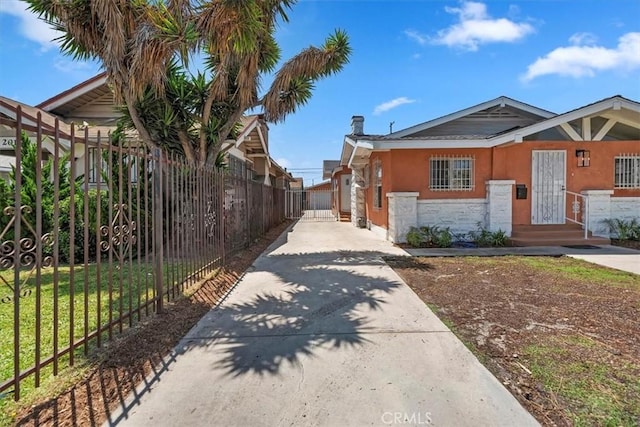 2018 W Martin Luther King Jr Blvd, Los Angeles, CA 90062 - view of side of property featuring driveway, stucco siding, and stone siding