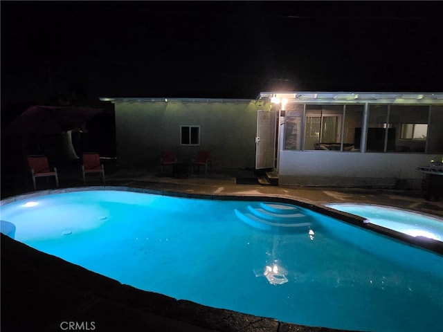 12995 Leith Way, Yucaipa, CA 92399 - pool at twilight featuring a pool with connected hot tub and a patio