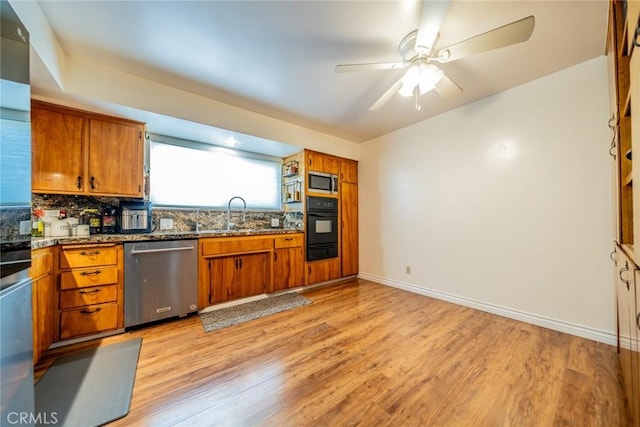 12995 Leith Way, Yucaipa, CA 92399 - kitchen featuring appliances with stainless steel finishes, a warming drawer, brown cabinetry, and light wood finished floors