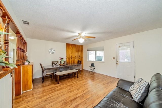 12995 Leith Way, Yucaipa, CA 92399 - living room with light wood finished floors, a ceiling fan, and a textured ceiling
