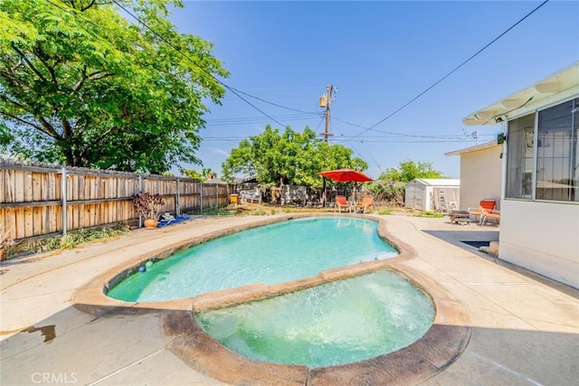 12995 Leith Way, Yucaipa, CA 92399 - view of pool featuring a storage unit, a fenced backyard, a patio, and a pool with connected hot tub
