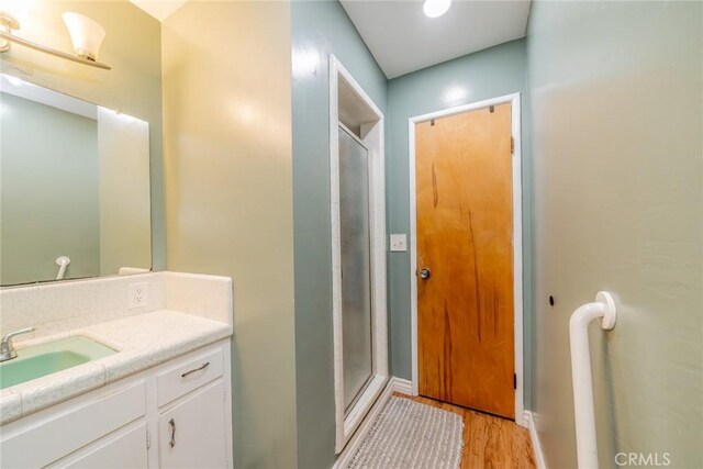 12995 Leith Way, Yucaipa, CA 92399 - full bath featuring vanity, a stall shower, and wood finished floors