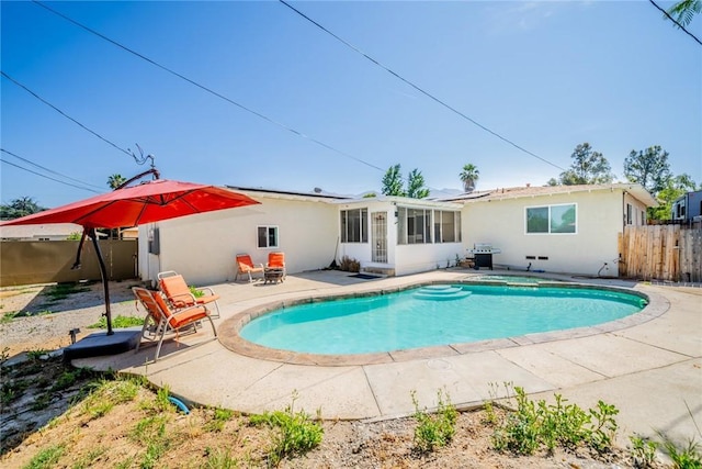 12995 Leith Way, Yucaipa, CA 92399 - rear view of house featuring a sunroom, a patio, and stucco siding